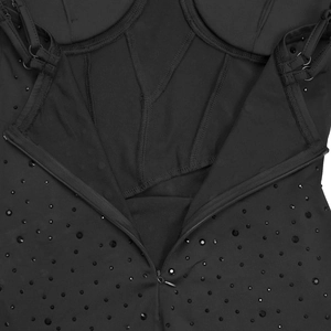 Close-up of black bodycon dress featuring rhinestone detailing and supportive boning structure