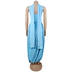 Detail view of sky blue sleeveless dress with back cascading ribbons and draped hemline