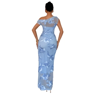 Detail of elegant light blue mesh evening gown featuring intricate 3D floral embroidery