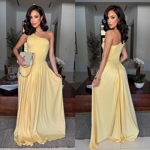 Detail of elegant one-shoulder pale yellow maxi dress with pleated waist and drape