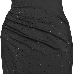 Detail of elegant black slim dress with sparkling rhinestones and side ruffle design