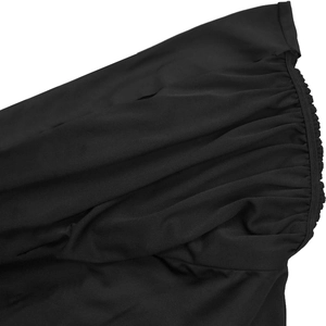 Detail shot of black bodycon set showing textured ruched fabric and elastic gathers