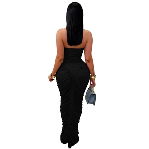 Detail of ruched back design on this slim fit black strapless fishtail maxi dress