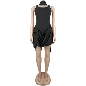 Detail of black sleeveless dress featuring ruffled asymmetric hem and matching neck strap