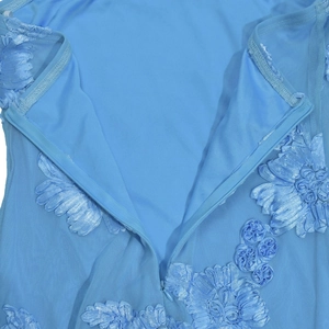 Détails d'appliqués floraux 3D et de broderies sur une robe dos nu bleu clair