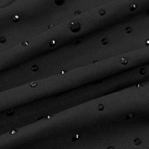 Macro detail of elegant black fabric featuring premium rhinestones and fine woven texture