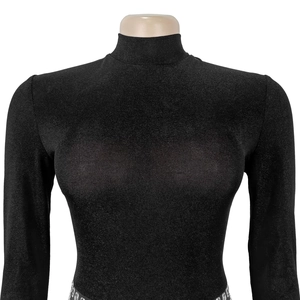 Detail of black high-neck jumpsuit featuring subtle shimmer texture and studded waist belt