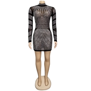 Detailed view of sheer black mesh mini dress with sparkling silver rhinestones and long sleeves