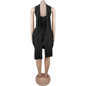 Detail of black backless mini dress with long decorative ribbons and bubble hem design