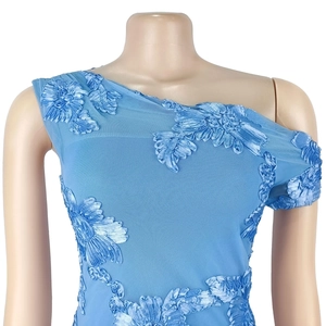 Detailed view of light blue mesh dress featuring 3D floral embroidery and one-shoulder cut