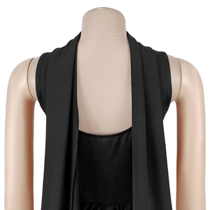 Detail of minimalist black sleeveless mini dress with elegant draped lapels and soft fabric