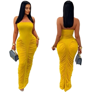 Detailed side view of ginger yellow strapless maxi dress with ruched texture design