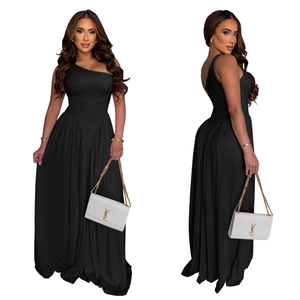 Detail of elegant black one-shoulder maxi dress with ruched waist and flowing skirt