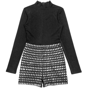 Detail of black long sleeve romper with sparkling geometric rhinestones and back zipper