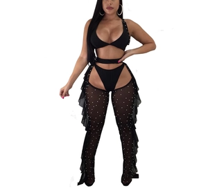 Detail of black mesh three-piece set featuring sheer flared pants with rhinestone accents