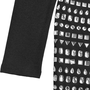 Detail of black long sleeve jumpsuit featuring geometric silver rhinestones and mesh texture
