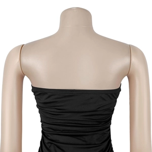 Detail view of the back of a black strapless tube dress with Ruched fabric texture