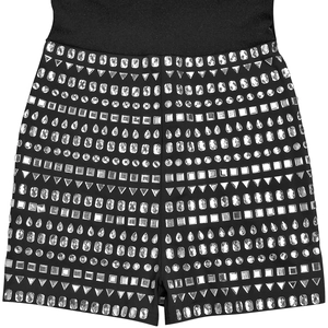 Detail shot of black slim fabric with silver rhinestones in varied shapes on the surface