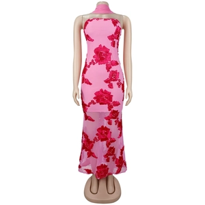 Détail de robe rose élégante avec broderies florales 3D rouges et texture en maille