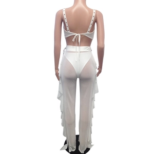 Close-up of white mesh three-piece set featuring sheer trousers with ruffled side details