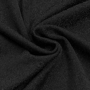 Detailed macro view of black sheer fabric with glittering rhinestones and fine mesh texture