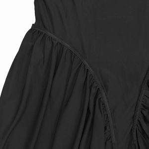 Close-up of black dress fabric with gathered elastic seam and ruched texture details
