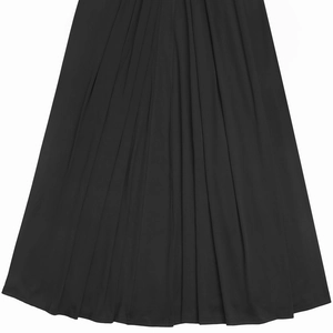 Detail of black pleated dress hem showing vertical micro pleats and premium fabric texture