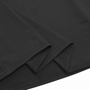 Detailed macro view of the high-quality double-stitch hem on black knit dress fabric