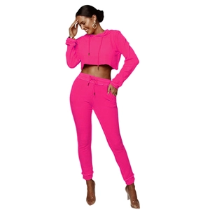 Dettaglio della tuta sportiva rosa neon a due pezzi con felpa corta e pantaloni sportivi