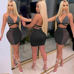 Women's black two-piece set with rhinestones, halter neck top and mesh patch mini skirt