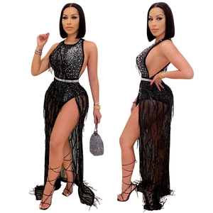 Detail of black sexy two-piece set with shiny rhinestones, sequins and long flowing tassels