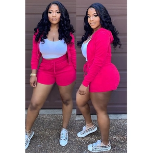 Detailed texture of pink velvet two-piece set featuring hooded jacket and drawstring shorts