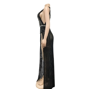 Detail of black V-neck dress featuring sparkling silver rhinestones and long fringe tassels