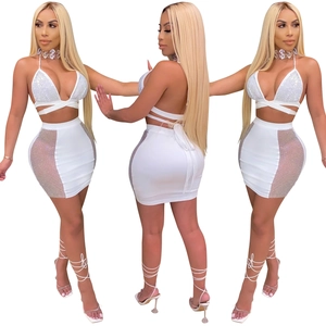 Detailed view of white two-piece set featuring rhinestone cross straps and mesh panels