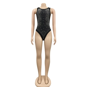 Close-up of black sleeveless bodysuit with silver rhinestones and fringe detail
