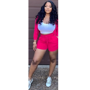 Detailed shot of women's 3-piece set with pink zip hoodie, white crop top and shorts