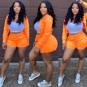 Women's 3-piece velvet lounge set with orange zip-up hoodie, vest, and drawstring shorts