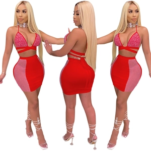 Detail of red two-piece party set with rhinestone halter top and mesh mini skirt