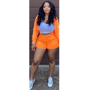 Detailed texture of women's orange velvet three-piece set with hoodie, vest and shorts