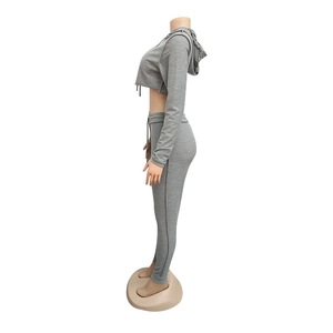 Dettagli della tuta grigia con felpa corta e pantaloni slim con coulisse in vita