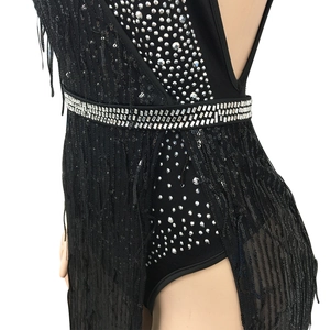 Close-up of black fringe dress featuring silver rhinestone belt and sequin mesh texture
