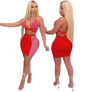 Detail of red two-piece set featuring cross bandage halter top with rhinestones and mesh skirt