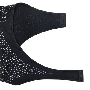 Detail of black rhinestone mesh dress showing triple snap button closures and gradient crystals