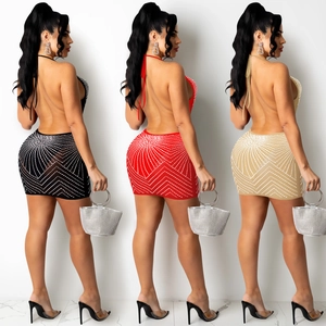 Detail of backless rhinestone mini dress in black, red, and khaki with geometric patterns