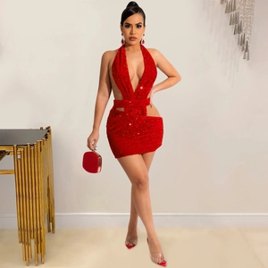 Detailed close-up of a red sequin halter dress with a deep V-neck and waist cutouts