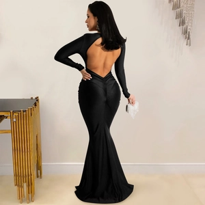 Detailed back view of a black long-sleeve backless evening gown with a fishtail hem