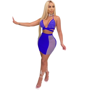Detail of royal blue rhinestone halter top with cross bandages and mesh patchwork skirt