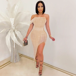 Detailed view of nude mesh dress featuring sparkling rhinestones and asymmetrical hem