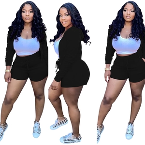 Detailed three-piece set with a black zip hoodie, white tank top and drawstring shorts
