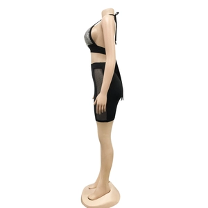 Detail view of black two-piece night club set featuring rhinestone halter top and mesh skirt